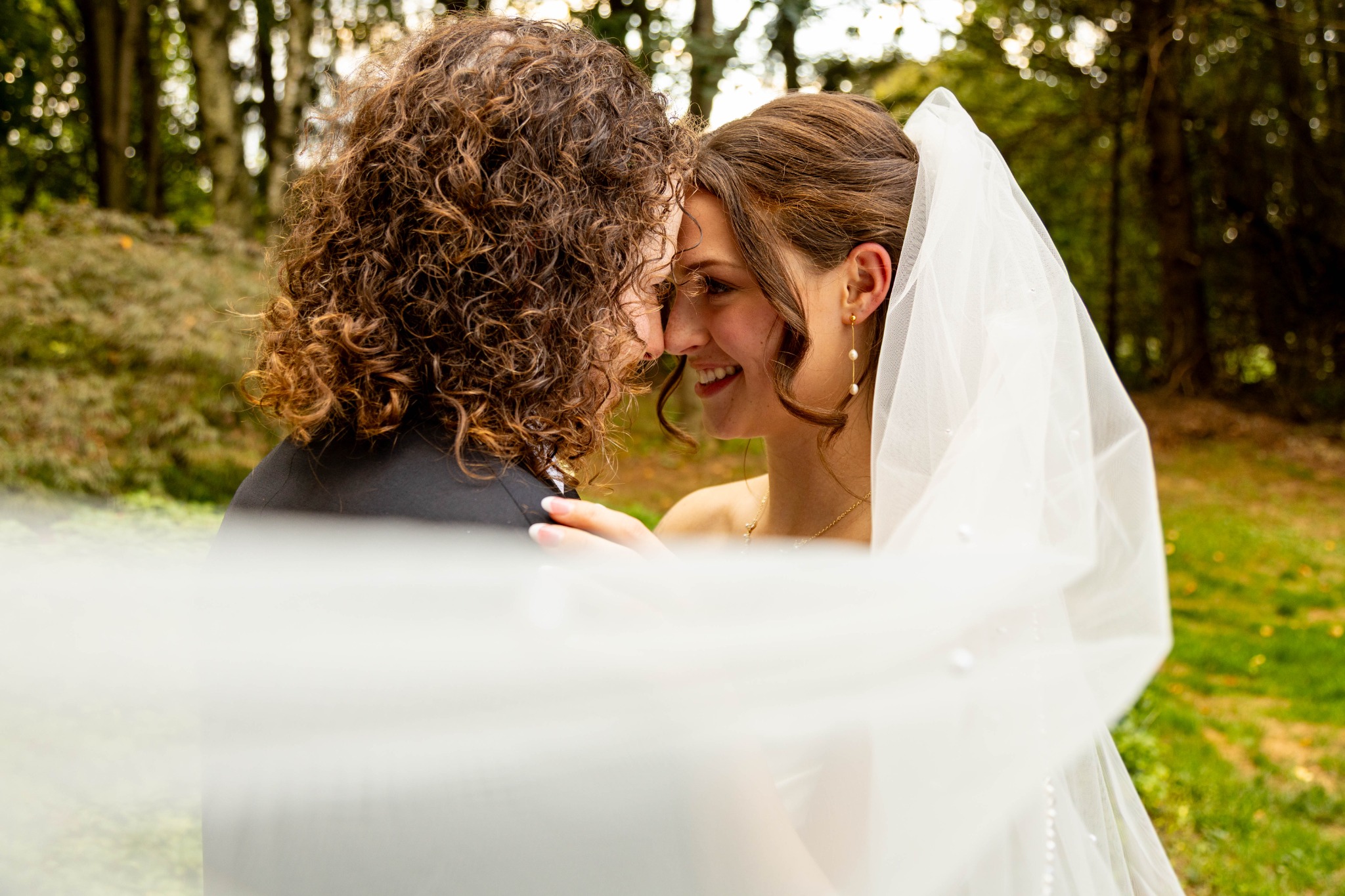 Bride and groom sharing an intimate wedding-day moment beneath a veil in Pennsylvania